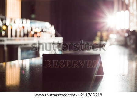 Reserved. Picture of reservation card on the bar counter
