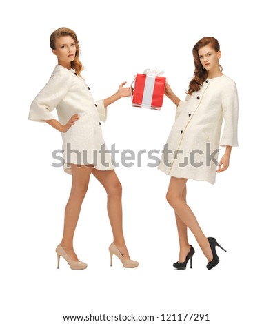 picture of two teenage girls in white coats with present box
