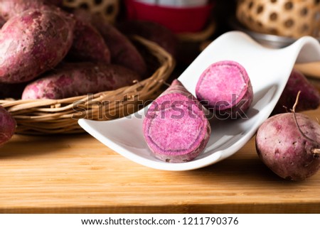 Sweet Potatoes Purple Colored on Wood Table background