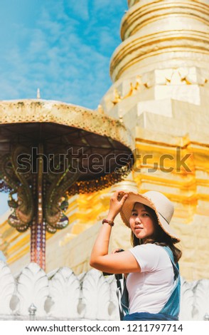Young traveller enjoying a looking at wat phra that chae haeng temple, Nan, Thailand . Traveling Asia, active lifestyle concept.vintage tone.