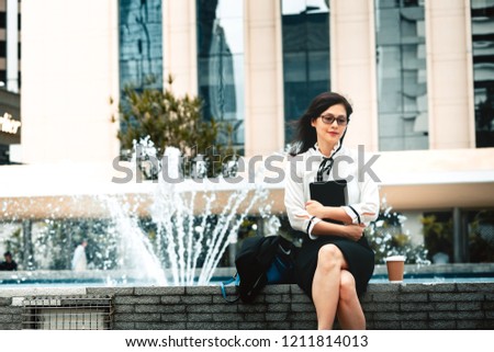 Business woman using electronic device outdoor in the city 