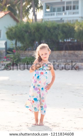 little beautiful girl posing on the beach