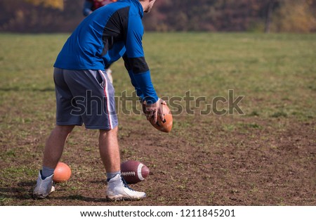 american football kicker practicing football kickoff closeup shot