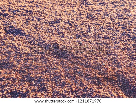 Footprints and service marks on tennis court details. Dry light red crushed bricks surface on outdoor tennis ground. Rough texture against sun