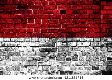 National flag of Indonesia on a brick background. Concept image for Indonesia: language , people and culture.