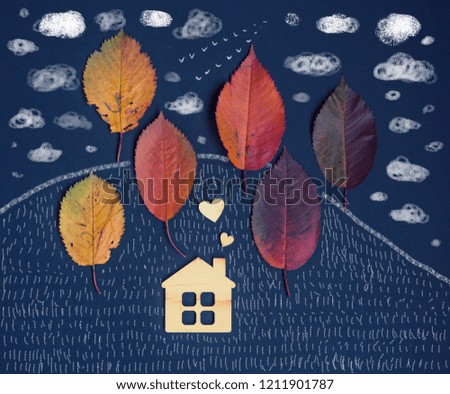autumn card with wooden house and autumn leaves on dark  background/housewarming/anti-season depression