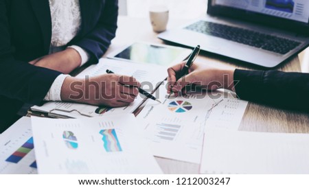 financial Image of two  business people pointing at business document presentation summary report , during discussion at meeting , Notebook on wood table