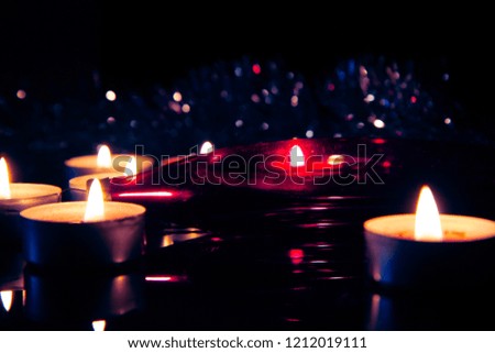 Christmas candles atmospheric lights on a blurred background with bokeh effect. Christmas and New Year holiday background concept. Copy space for text.