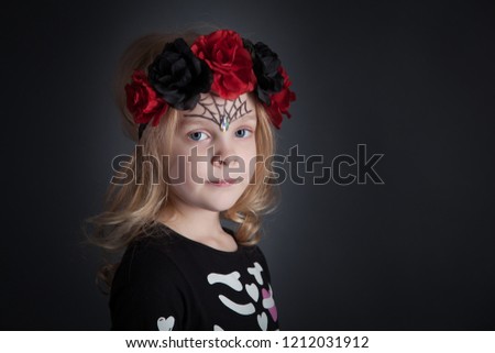 Light hair girl posing on dark grey background in halloween outfit