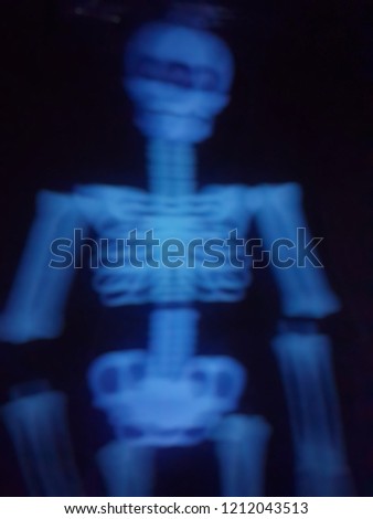 A blurred picture of skeleton of ghost that light in the dark. Decoration in Halloween theme. Ghost and horror. 