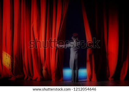 The actor in a tuxedo theatre closes the curtain Royalty-Free Stock Photo #1212054646