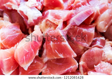 Full frame picture of fresh pork cut into pieces.