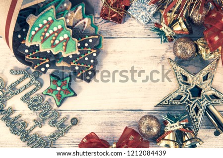 Beautiful Christmas composition and decoration with baked Christmas gingerbread cookies in paper bag on light wooden background  