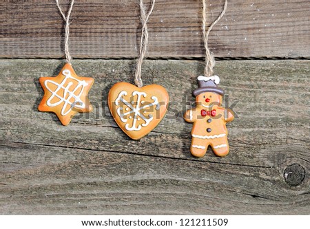 Christmas cookies hanging over wooden background