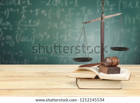 Justice Scales, gavel and books on light background