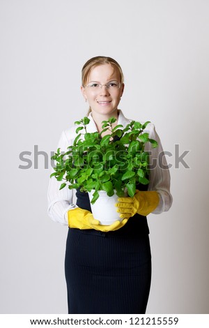 Successful business woman with a potted plant in the hands