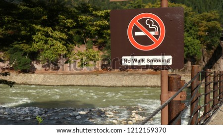 No walk smoking sign on wooden bridge at this area