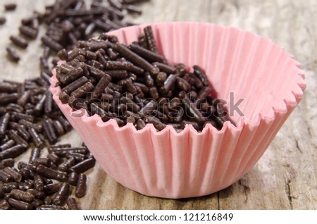 mini pink cupcake case with chocolate sprinkles