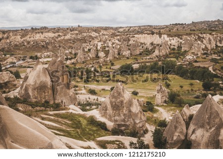 Epic landscape view over Cappadocia, located among the fairy chimney and volcanic rock formations clustered with spectacularly coloured valleys nearby.