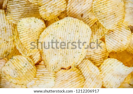 Potato chips corrugated background top view, close-up