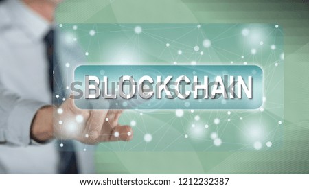 Man touching a blockchain concept on a touch screen with his finger