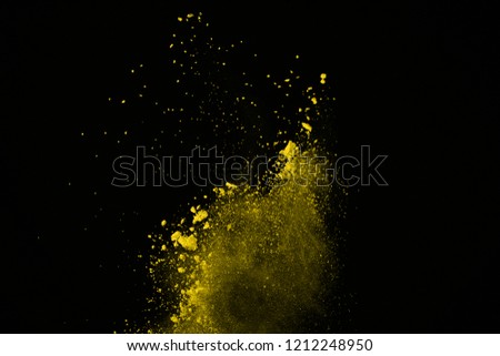 Gold powder particles explosion. Glitter burst with golden texture. Yellow color dust splash for fashion background.