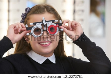 ophthalmologist examining little girl with modern equipment