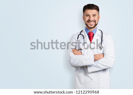 Portrait with copy space of cheerful joyful doc with bristle in white lab coat and stethoscope on his neck, having his arms crossed, looking at camera, isolated on grey background Royalty-Free Stock Photo #1212290968