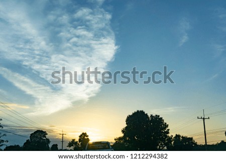 Natural Sunset or Sunrise Over Field Or Meadow. Bright Dramatic Sky And Dark Ground. Countryside Landscape Under Scenic Colorful Sky