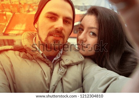 Loving couple taking selfie in winter with city panorama. Happy in Germany