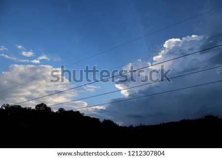 Blue sky with cable and clouds background. Beautiful white fluffy clouds on light blue sky background. Clearing day and Good weather in the morning.It's beautiful picture.It was taken in the morning.