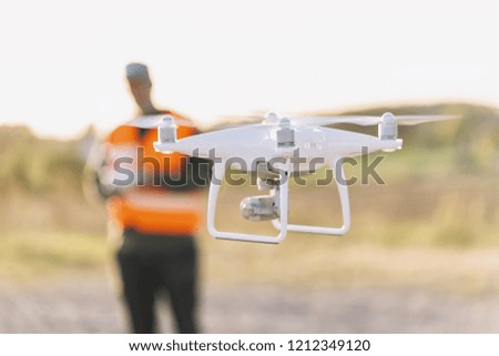 Drone inspection. Operator inspecting construction building site flying with drone