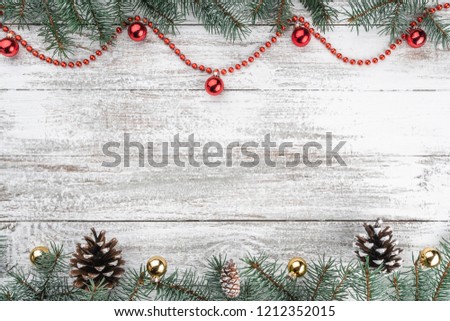 Old wooden Christmas background. Fir branches and cones. Gold and red baubles and garlands. Top view. Space for your text. Xmas card.