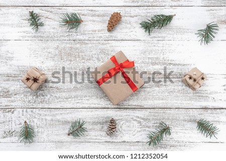 Old wooden Christmas background. Tree branches and cones. Xmas Gifts. Top view.