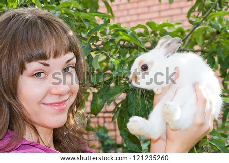 beautiful young woman with a rabbit  in hands