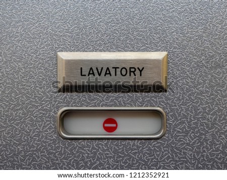 Airplane lavatory with red "occupied" symbol Royalty-Free Stock Photo #1212352921