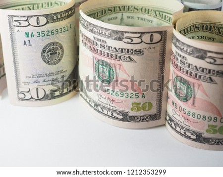 roll up set of new design dollar bill as background.