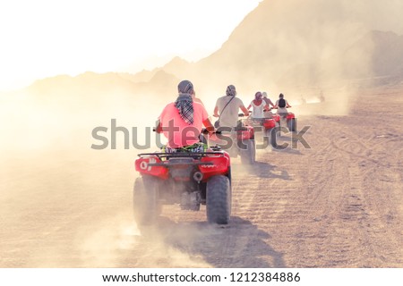 Desert in Egypt. Sharm el Sheikh. Sand and Sand Borkhan. Rock and sunset. Quad Cycle Travel. Excursion with people.