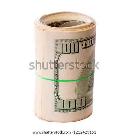 Money dollars, wound up in a twist and tied with a rubber band. Isolate on white background. Cash, banknotes twisted by a rubber band in a roll, on a white background.