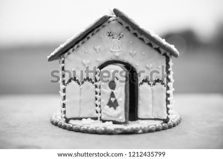 Gingerbread house. Christmas holiday sweets. European Christmas holiday traditions. Black and white photography.