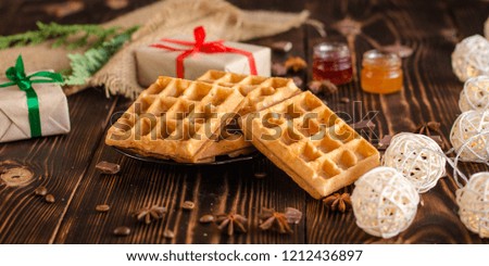 fresh belgian Tasty waffles and gifts on a wooden background. top view.
