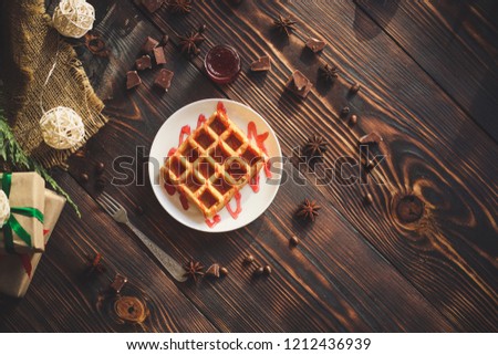 fresh belgian Tasty waffles and gifts on a wooden background. top view.
