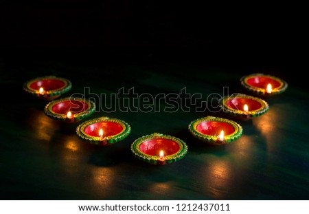 Happy Diwali - Diya lamps lit during Diwali celebration. Greetings Card Design of Indian Hindu Light Festival called Diwali