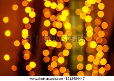 beautiful blurred garland on a yellow background with small circles