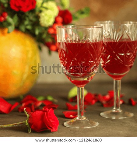 red wine in a glass and flowers on a wooden background. top view.
