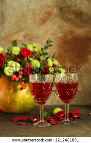 red wine in a glass and flowers on a wooden background. top view.
