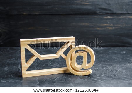 Envelope and email symbol on a dark concrete background. Concept email address. Internet technologies and contacts for communication. Communication over the network, business and correspondence.