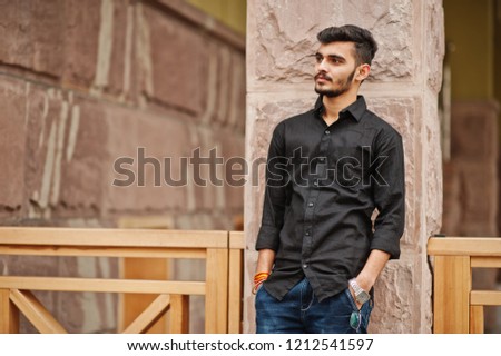 Indian stylish man at black shirt posed outdoor.