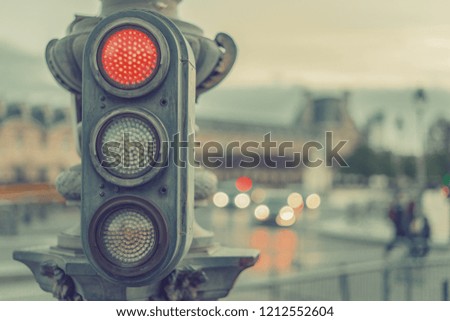Retro pedestrian traffic light showing red signal. Sunset lights. Vintage classic european city background. Vintage effect.