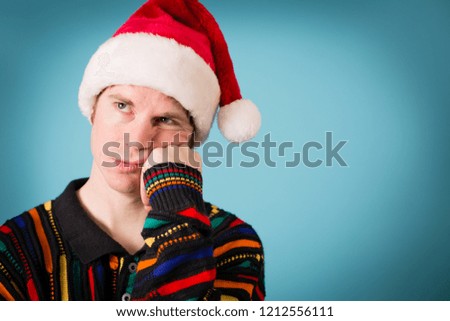 Bored Christmas Man in Ugly Sweater and Santa Hat